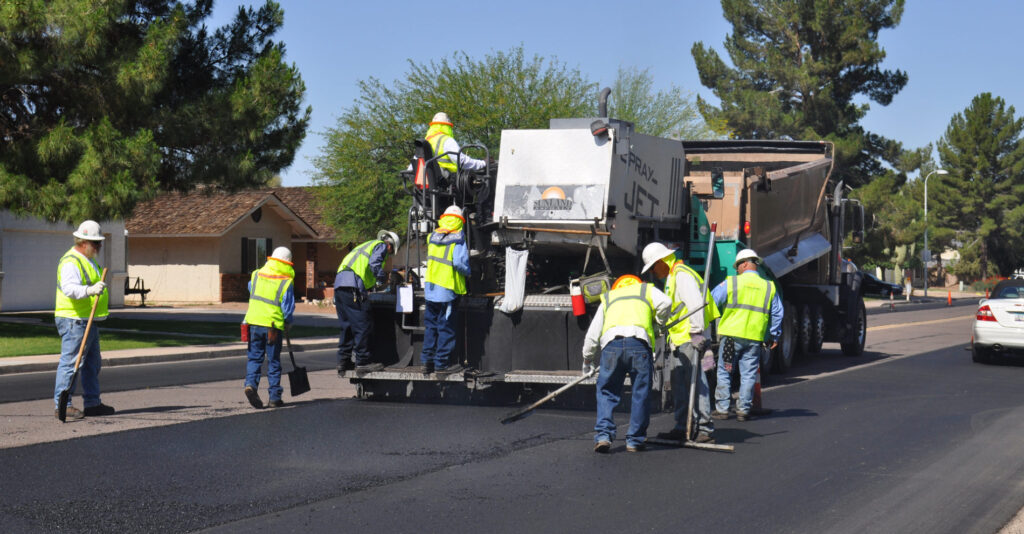 Crew laying fresh asphalt on a Cape Coral road
